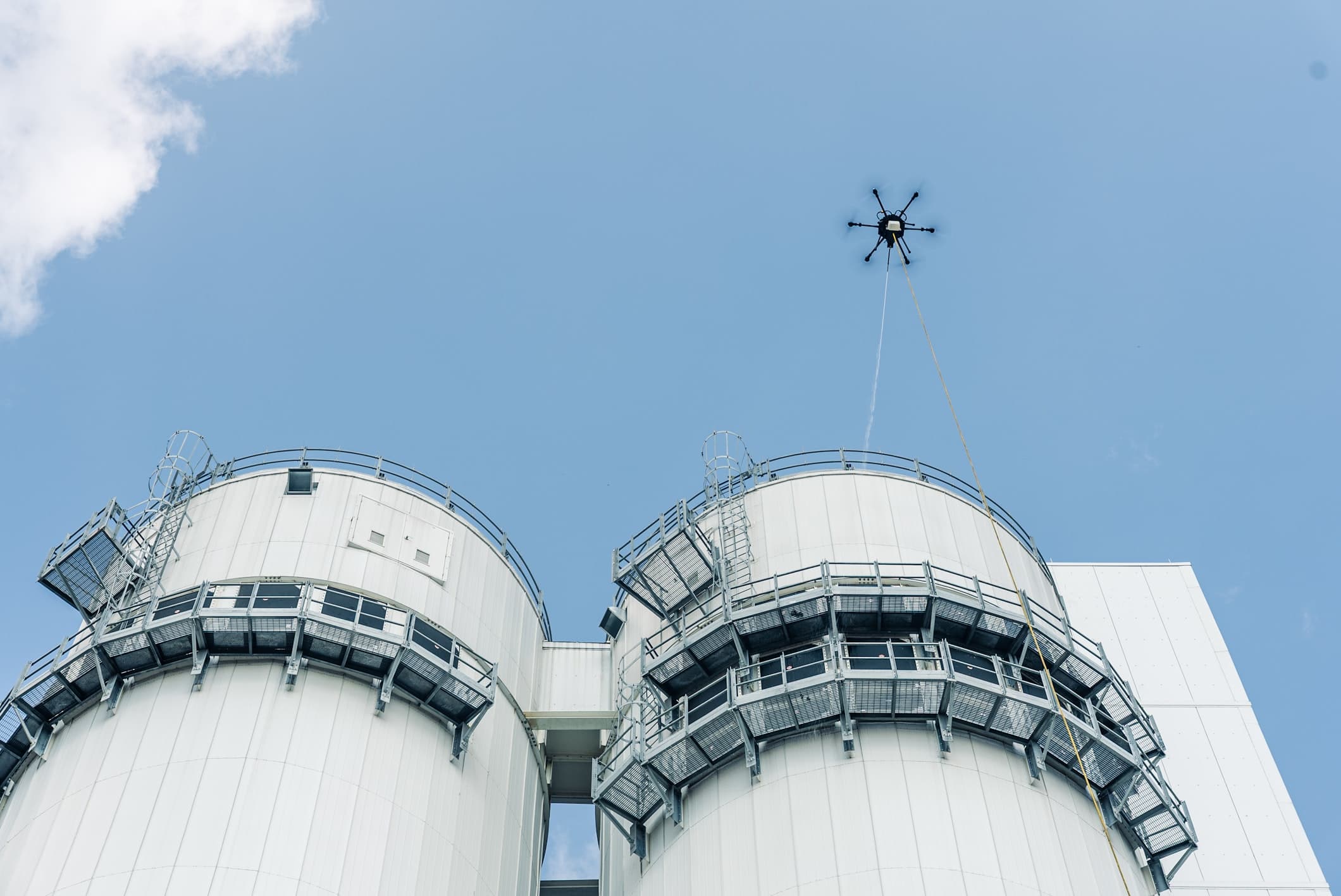 Sherpa Drone cleaning the exterior of a multi-story commercial building